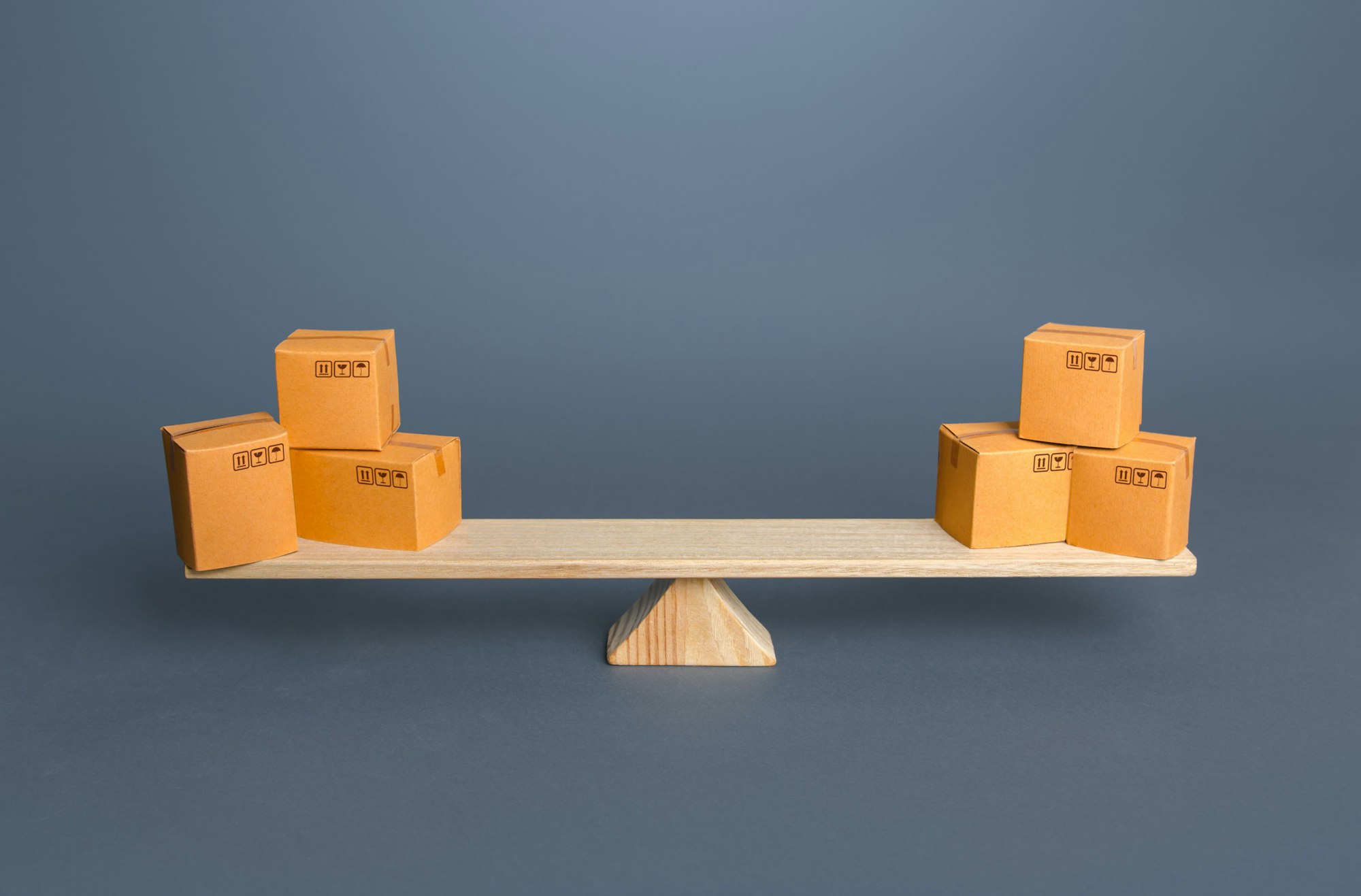 Boxes on scales. Trade balance. Economic relations. Buying, selling or bartering goods